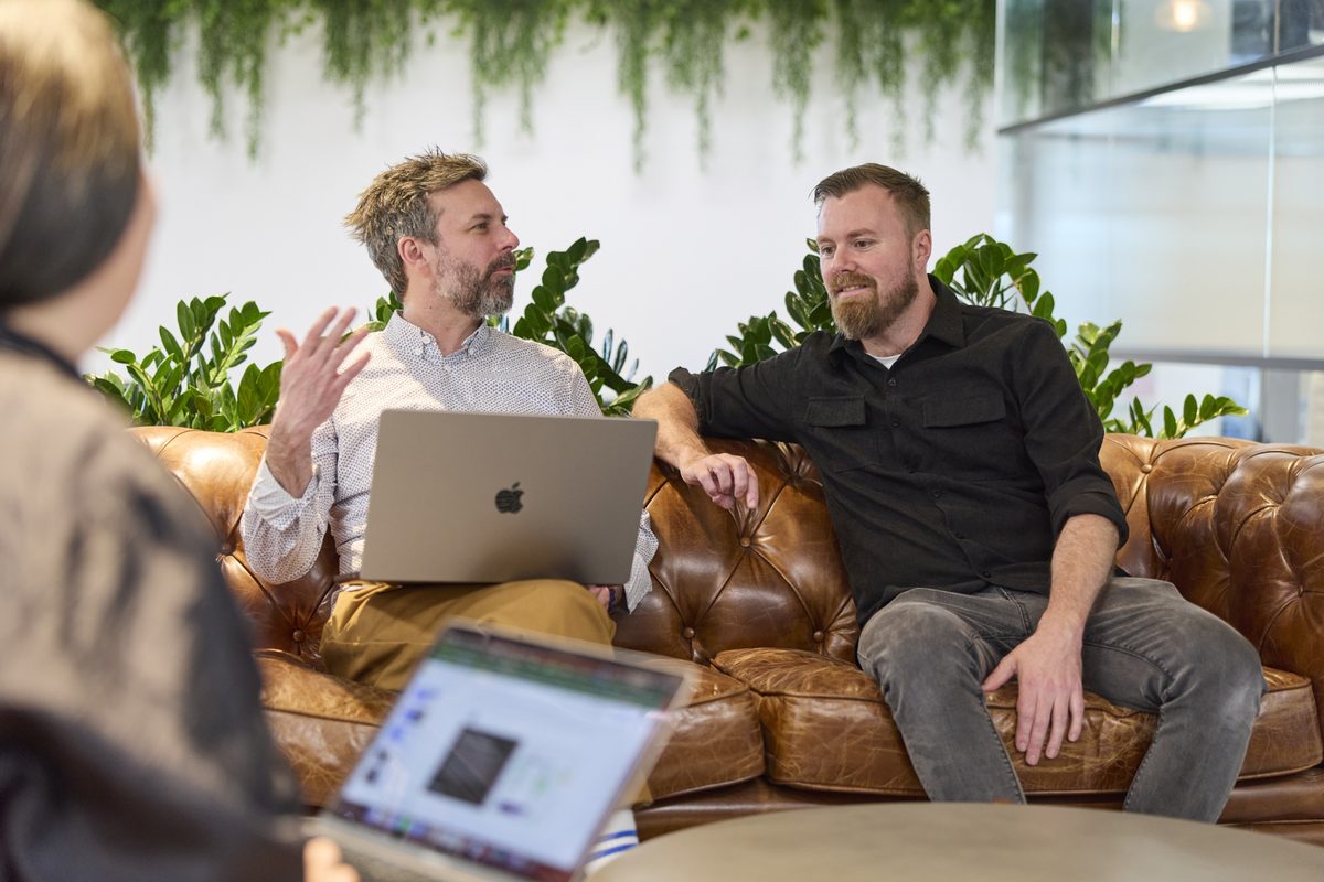Conduct team discussing ideas in studio lounge