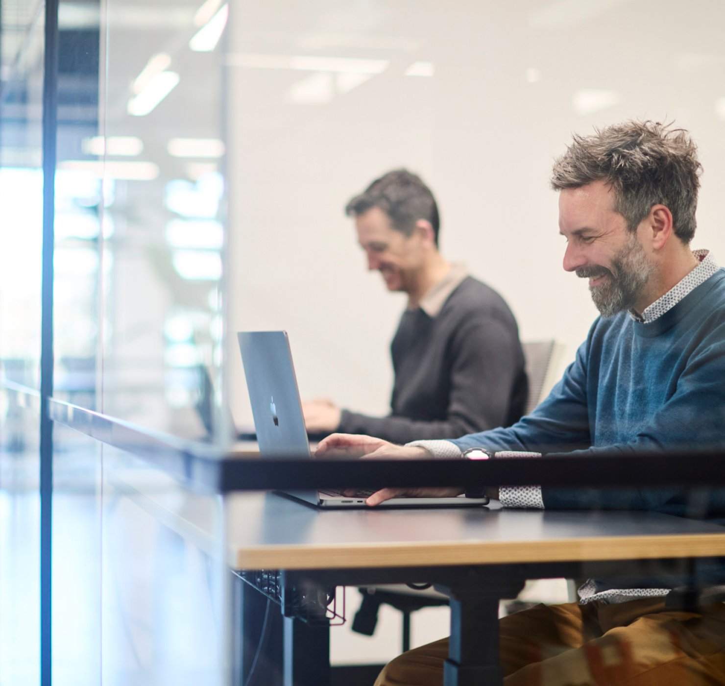 Conduct designers working on laptops in a research workshop session for Victoria Police