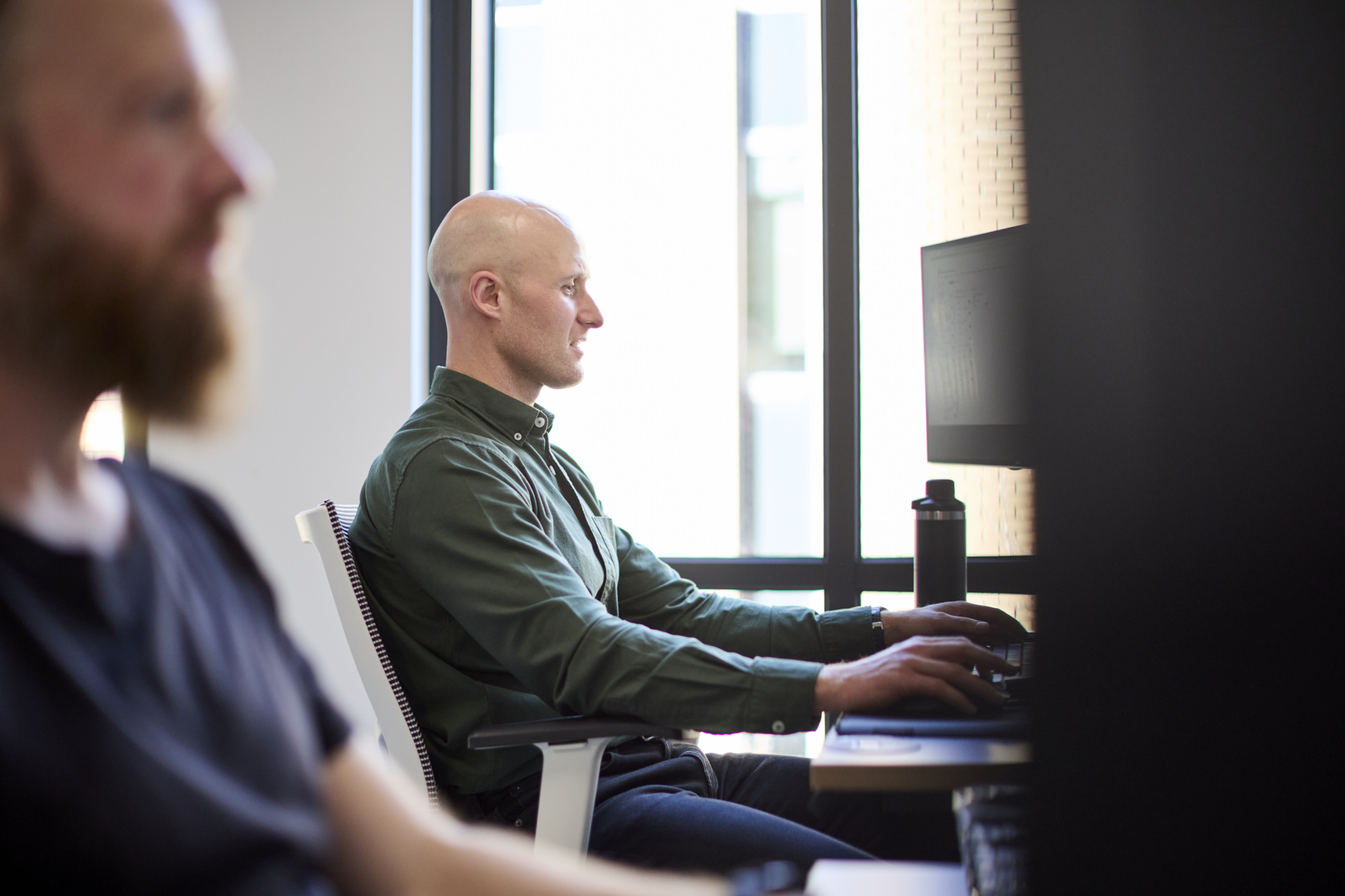 Conduct software engineer writing code at a workstation