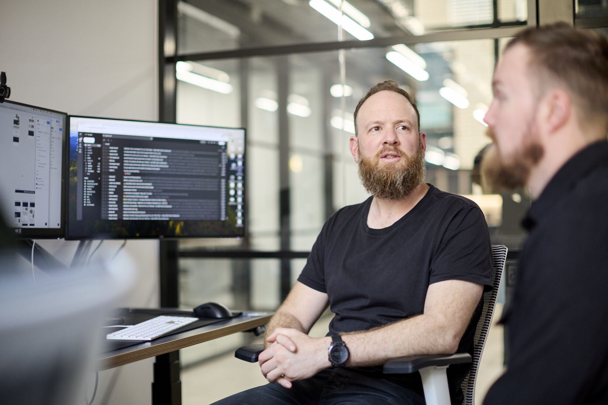 Two Conduct team members reviewing work at a desk