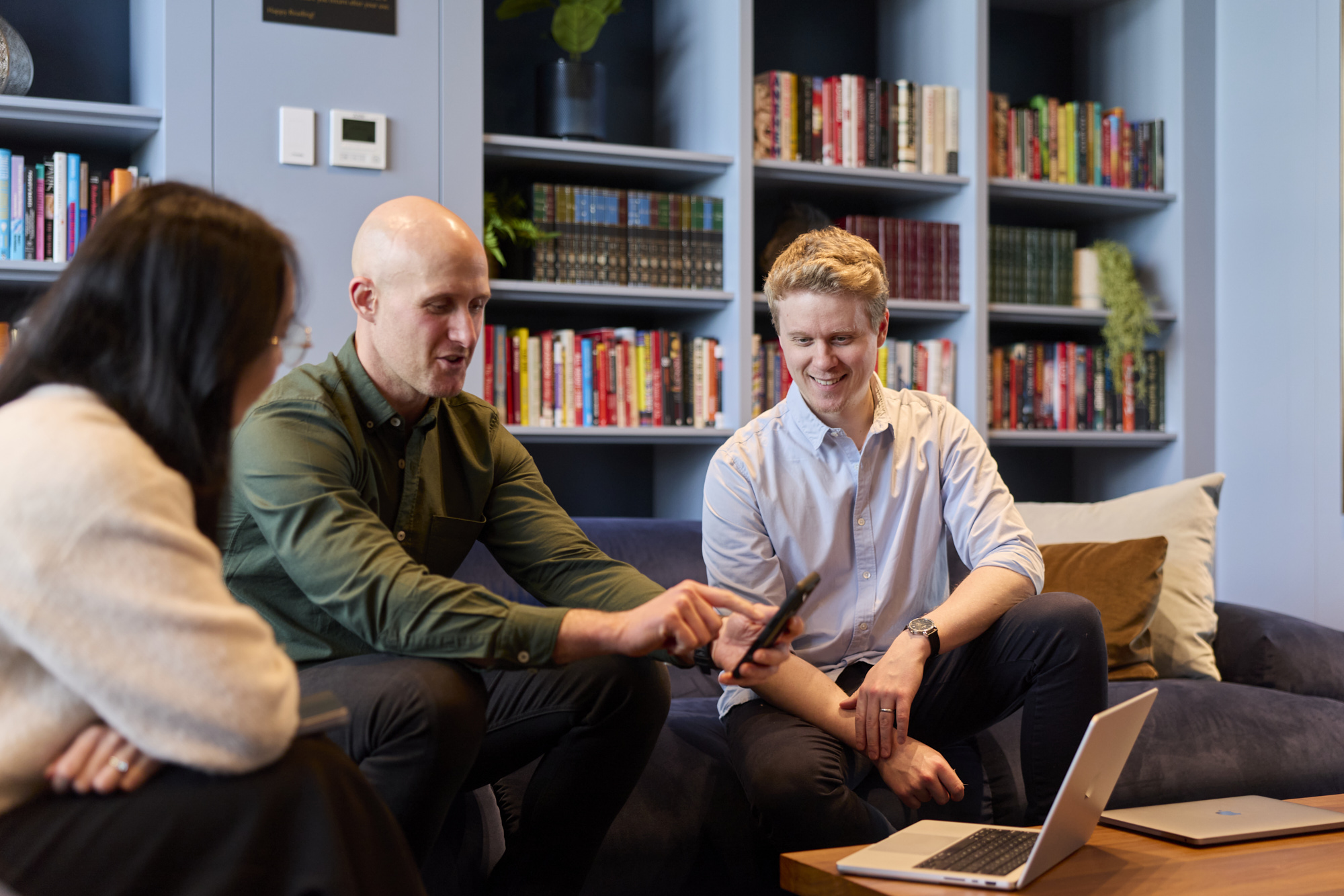 Conduct team collaborating over a laptop